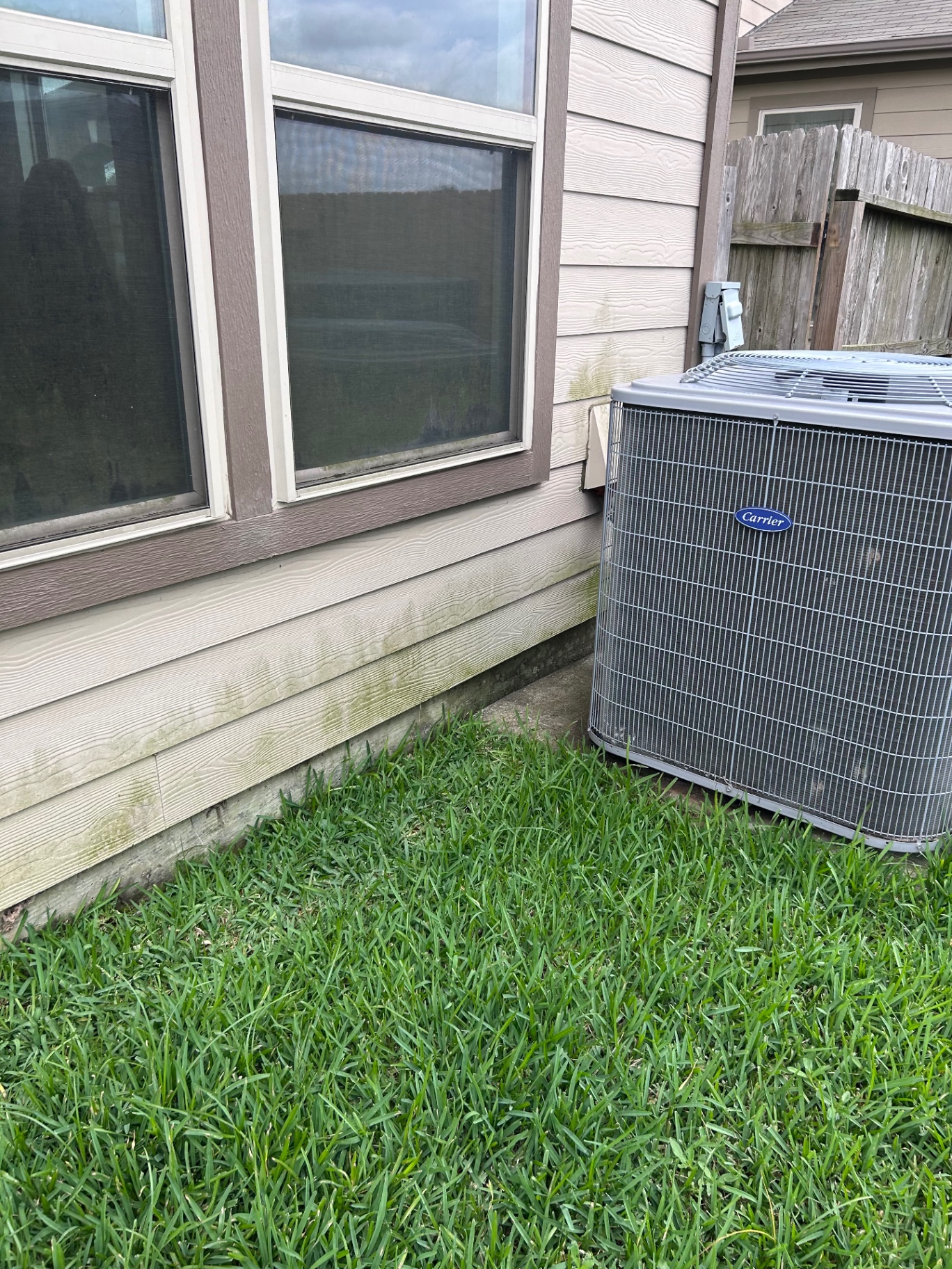 Dirty house siding covered in mildew and grime before soft washing in Cypress, TX